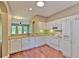 Open kitchen with white appliances and cabinets, plus granite countertops at 18827 Duquesne Dr, Tampa, FL 33647