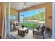 Relaxing lanai with comfortable seating and a stunning lake view at 18827 Duquesne Dr, Tampa, FL 33647