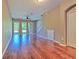 Spacious living room with hardwood floors, natural light, and access to a staircase at 18827 Duquesne Dr, Tampa, FL 33647