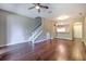 Open concept living room with staircase and entryway leading to the kitchen at 18827 Duquesne Dr, Tampa, FL 33647