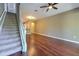 Living room with hardwood floors, staircase, and ceiling fan at 18827 Duquesne Dr, Tampa, FL 33647
