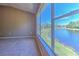 Main bedroom with large windows, lake views, and neutral carpet flooring at 18827 Duquesne Dr, Tampa, FL 33647