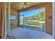 Enclosed patio with fan, sliding glass doors, and beautiful lake view at 18827 Duquesne Dr, Tampa, FL 33647