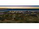 Beautiful aerial view of waterfront condos, lush golf course, and stunning bay at sunset at 2617 Cove Cay Dr # 604, Clearwater, FL 33760