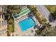 Aerial view showcases a pristine community pool and shuffleboard area at 2617 Cove Cay Dr # 604, Clearwater, FL 33760