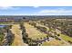 Expansive aerial view of a meticulously landscaped golf course and surrounding greenery, with a distant cityscape at 2617 Cove Cay Dr # 604, Clearwater, FL 33760