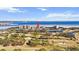 Aerial view showcases the waterfront condos surrounded by a lush green golf course with water views at 2617 Cove Cay Dr # 604, Clearwater, FL 33760