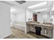 Bathroom with granite countertop, double sinks and wood-look floors at 2617 Cove Cay Dr # 604, Clearwater, FL 33760