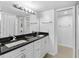 Bathroom with double sinks, black countertops, and modern lighting at 2617 Cove Cay Dr # 604, Clearwater, FL 33760