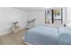 Spacious bedroom featuring simple, modern décor and a large window with a palm tree view at 2617 Cove Cay Dr # 604, Clearwater, FL 33760