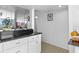 A well-lit kitchen with a breakfast bar overlooks a living area with water views at 2617 Cove Cay Dr # 604, Clearwater, FL 33760