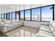 Spacious sunroom filled with lots of natural light, white couches, and water views at 2617 Cove Cay Dr # 604, Clearwater, FL 33760
