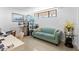Bright living area with a comfortable sofa, art display, and natural light from the window at 2617 Cove Cay Dr # 604, Clearwater, FL 33760
