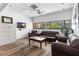 Comfortable living area featuring a brown leather sofa and armchairs, with a mounted TV at 2617 Cove Cay Dr # 604, Clearwater, FL 33760