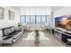 Contemporary living room with water views, tile floors, and stylish modern furniture at 2617 Cove Cay Dr # 604, Clearwater, FL 33760