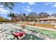 Community shuffleboard and cornhole courts surrounded by lush tropical foliage at 2617 Cove Cay Dr # 604, Clearwater, FL 33760