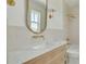 Light and bright bathroom features white marble countertop, brass fixtures, subway tile and custom mirror at 323 Appian Ne Way, St Petersburg, FL 33704
