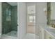 Bathroom with tile and walk-in shower and gold finishes, with a bedroom in the background at 323 Appian Ne Way, St Petersburg, FL 33704