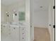 Elegant bathroom featuring double vanities with marble countertops and stylish fixtures, adjoining a bright, airy room at 323 Appian Ne Way, St Petersburg, FL 33704
