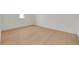 Bright bedroom features light wood floors, white trim, and a large window with lots of natural light at 323 Appian Ne Way, St Petersburg, FL 33704