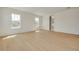 A view of a large bedroom with hardwood floors and abundant light from the large windows at 323 Appian Ne Way, St Petersburg, FL 33704