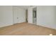 Bright bedroom features light wood floors and an ensuite bathroom with double sinks at 323 Appian Ne Way, St Petersburg, FL 33704