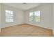Inviting, naturally-lit bedroom featuring light wood floors, white walls and large picture windows at 323 Appian Ne Way, St Petersburg, FL 33704