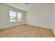 Clean, bright bedroom with wood flooring and a large window providing natural light at 323 Appian Ne Way, St Petersburg, FL 33704