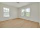 Large bright bedroom with light hardwood floors and two large windows at 323 Appian Ne Way, St Petersburg, FL 33704
