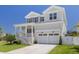 Charming two-story home with a covered front porch, two-car garage and well manicured lawn at 323 Appian Ne Way, St Petersburg, FL 33704