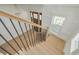 View of the home's entry foyer from the second floor landing featuring wood stairs and wrought iron railing at 323 Appian Ne Way, St Petersburg, FL 33704