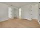 Spacious hallway with wood flooring and white trim, leading to multiple rooms at 323 Appian Ne Way, St Petersburg, FL 33704