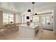 Bright kitchen with marble island, stainless steel appliances, and an open floor plan to dining and living areas at 323 Appian Ne Way, St Petersburg, FL 33704