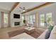 Spacious living room features a cozy fireplace, beamed ceilings, and French doors leading to the patio at 323 Appian Ne Way, St Petersburg, FL 33704