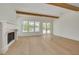 The living room features hardwood floors, beamed ceiling, and a fireplace at 323 Appian Ne Way, St Petersburg, FL 33704