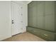Mud room with olive built-in cabinets, bench, and brick floors at 323 Appian Ne Way, St Petersburg, FL 33704