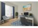 Charming home office provides a tranquil workspace with a comfortable chair, artwork, and blue accents at 323 Appian Ne Way, St Petersburg, FL 33704