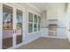 Inviting outdoor kitchen featuring stainless steel grill and a white tiled backsplash on a covered porch at 323 Appian Ne Way, St Petersburg, FL 33704