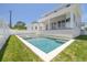 The backyard shows a new pool and spa combination with a spacious yard at 323 Appian Ne Way, St Petersburg, FL 33704