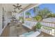 Virtually staged outdoor living space with comfortable seating, ceiling fans, and beautiful views at 323 Appian Ne Way, St Petersburg, FL 33704