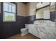 Chic powder room with statement mirror, a marble counter, and moody lighting at 323 Appian Ne Way, St Petersburg, FL 33704