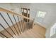 Bright foyer with an oak staircase and a modern chandelier, offering a warm welcome at 323 Appian Ne Way, St Petersburg, FL 33704