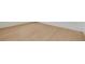 Close up of a beautiful light colored wood floor with white baseboard at 323 Appian Ne Way, St Petersburg, FL 33704