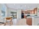 Well-equipped kitchen with wooden cabinets, black appliances, and easy access to the screened lanai at 3818 Cat Mint St, Tampa, FL 33619