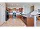 Spacious kitchen with stainless steel appliances, dark cabinetry, and a convenient breakfast bar at 3818 Cat Mint St, Tampa, FL 33619