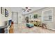 Inviting living room showcases a vibrant sofa, soft ottoman, and a wall of books at 3818 Cat Mint St, Tampa, FL 33619