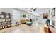 Bright living room boasts large windows and a ceiling fan, complemented by stylish, comfortable furniture at 3818 Cat Mint St, Tampa, FL 33619