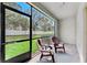 Screened lanai with seating, overlooking a well-maintained backyard at 3818 Cat Mint St, Tampa, FL 33619