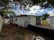 Backyard featuring a storage shed with white walls and some yard work needing completion at 8302 N Lois Ave, Tampa, FL 33614
