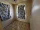 Modest bedroom with tile floors and two windows draped with patterned curtains for privacy and style at 8302 N Lois Ave, Tampa, FL 33614